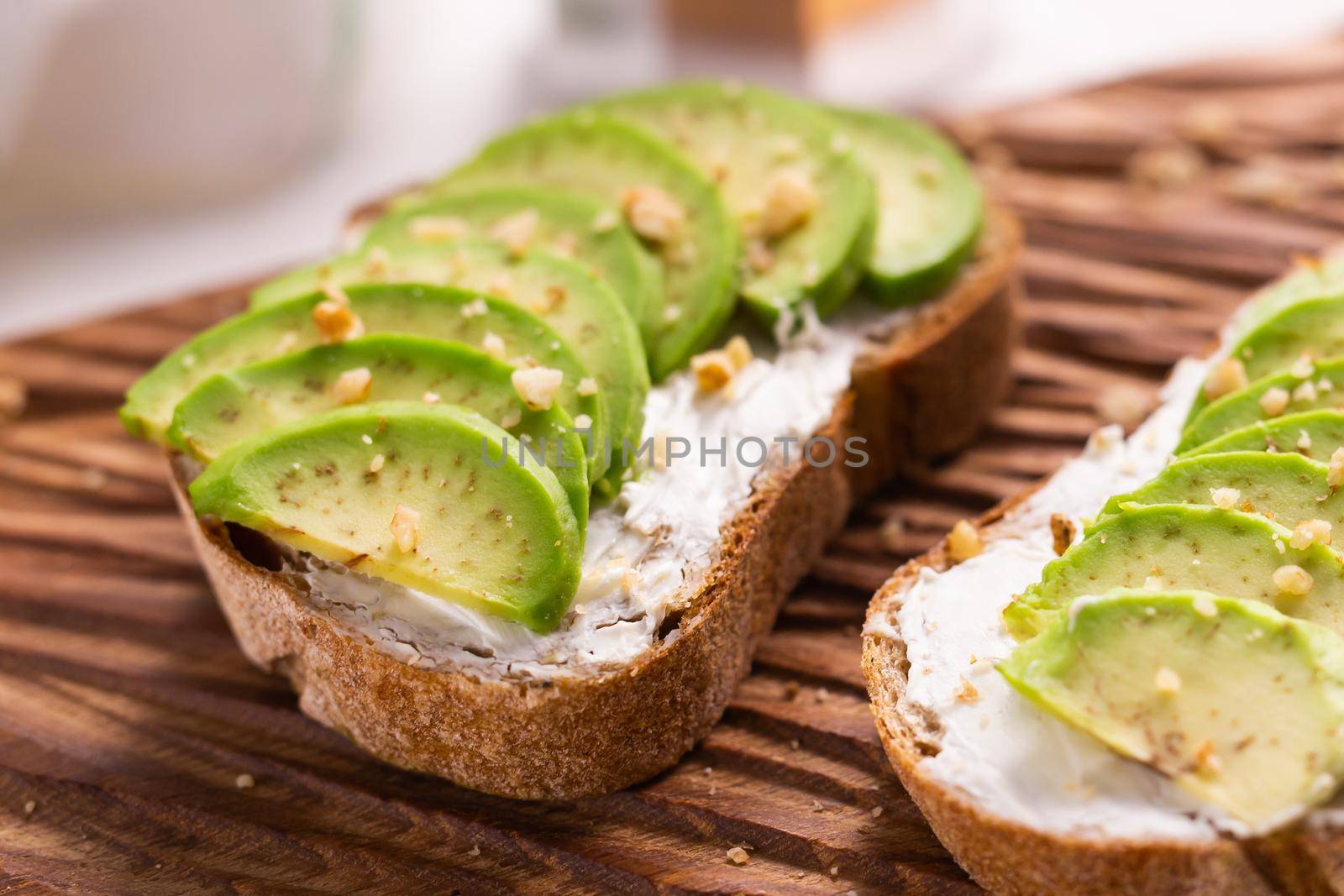Avocado sandwich on dark rye bread made with fresh sliced avocados from above. Breakfast concept. by Satura86