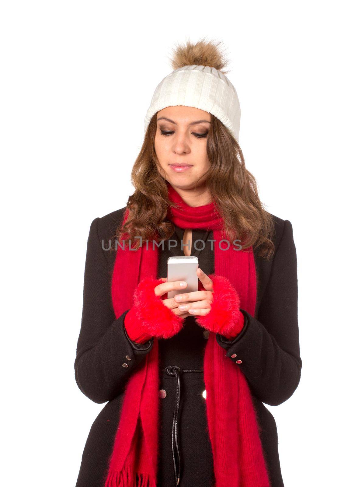 Portrait of the beautiful sexual girl in warm hat and coat on white background