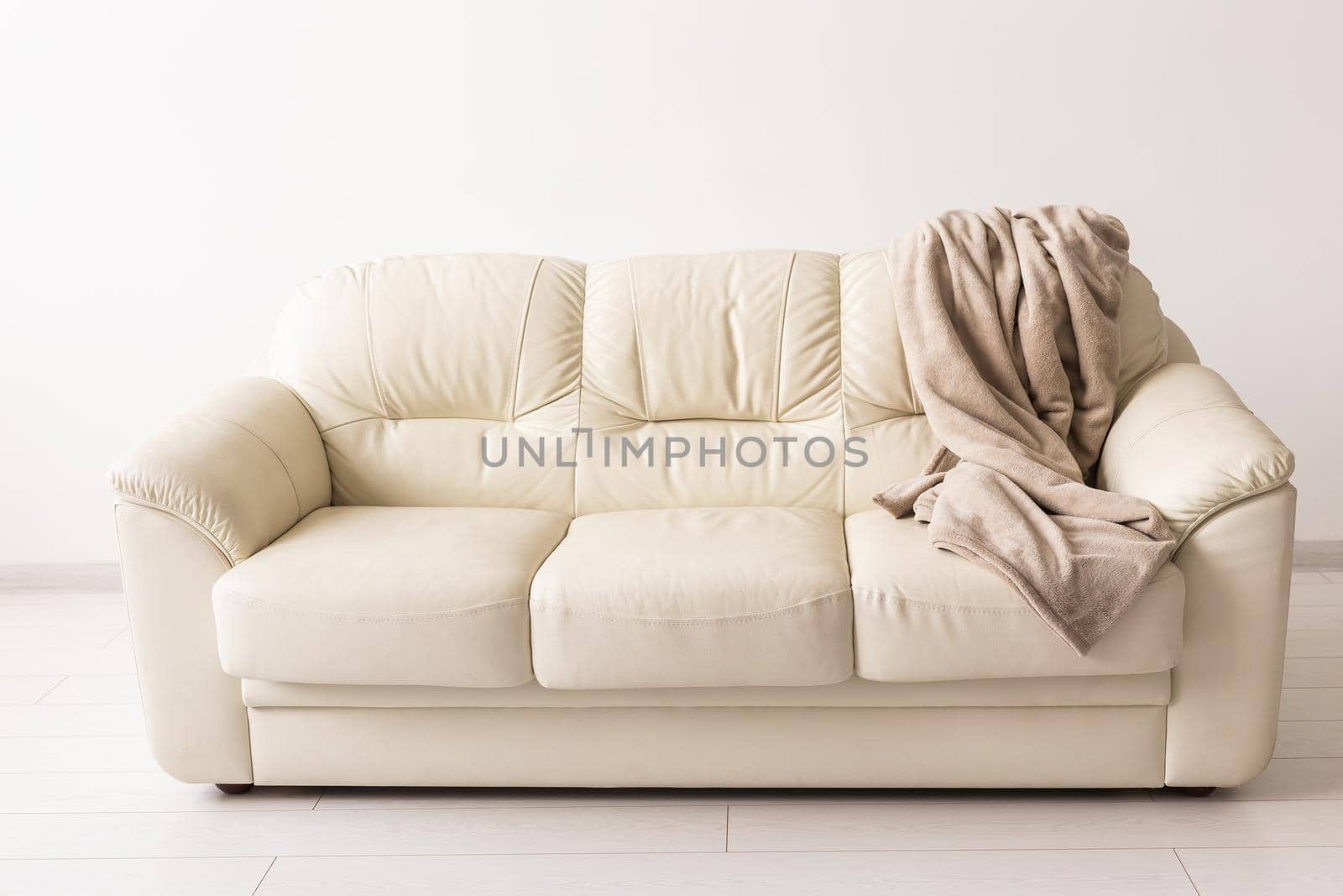 Beige sofa in room on white background. Simple minimalistic design