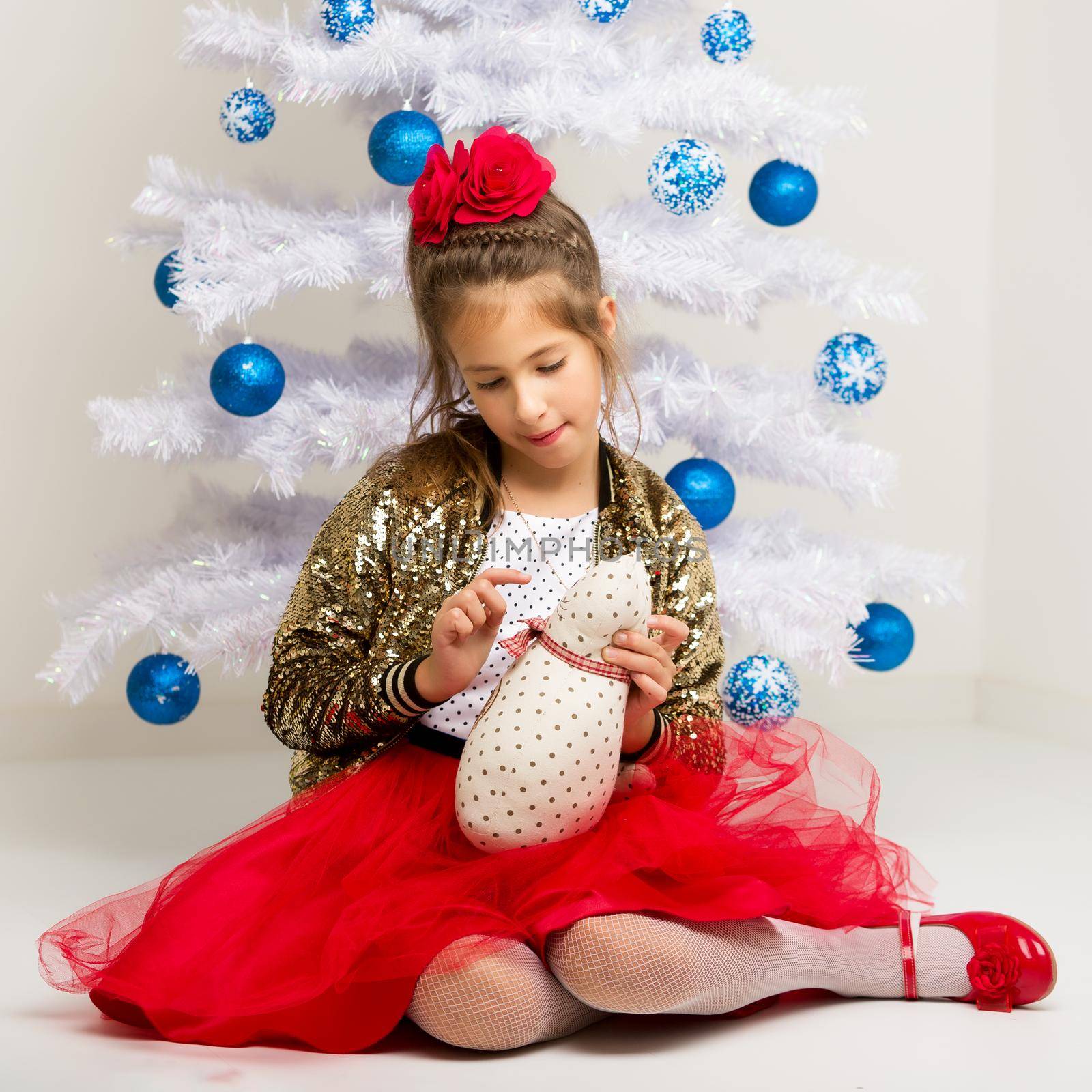 The girl at the Christmas tree.Beautiful little girl near the Ch by kolesnikov_studio