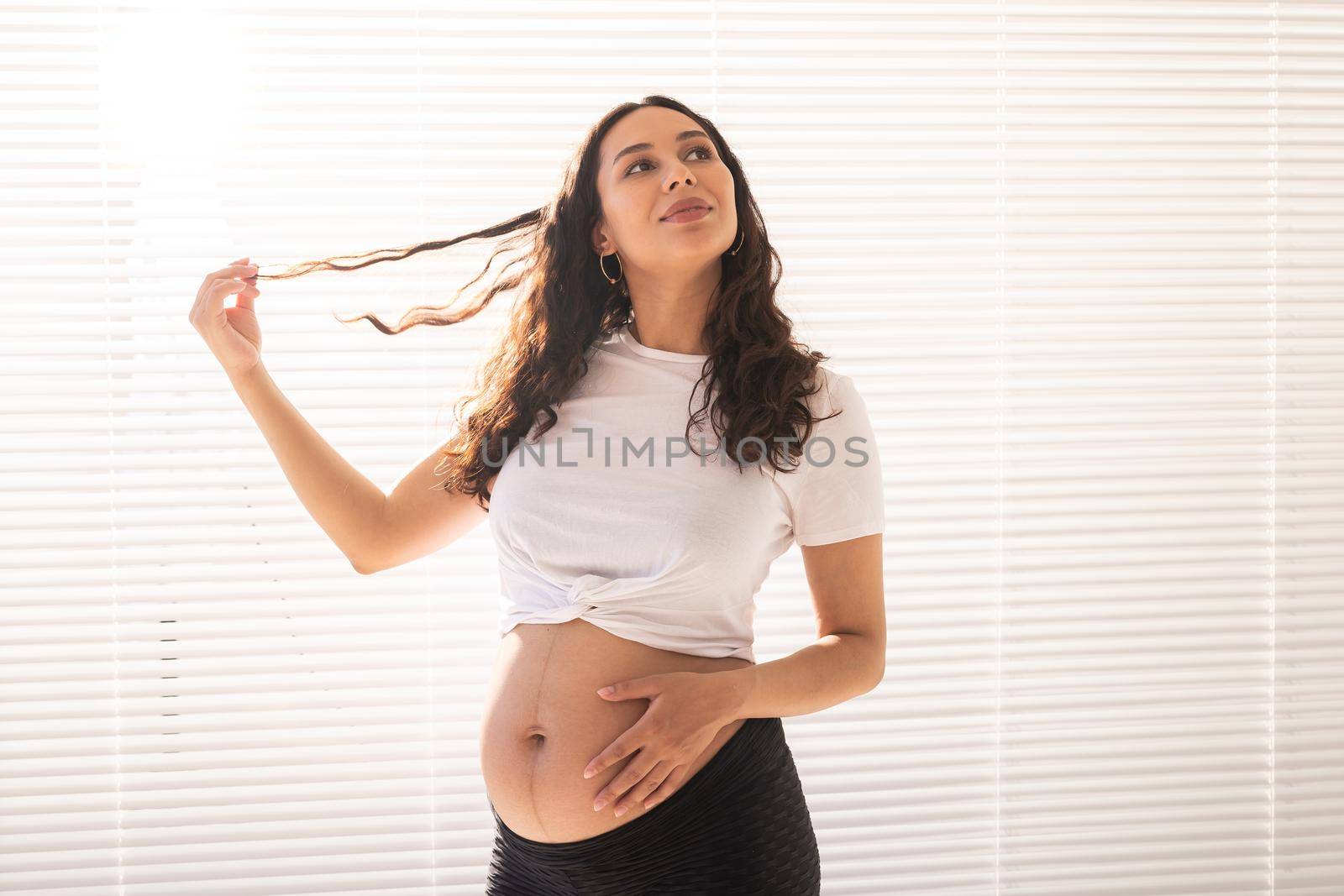 Pregnant woman touching her belly, copy space. Pregnancy and maternity leave.