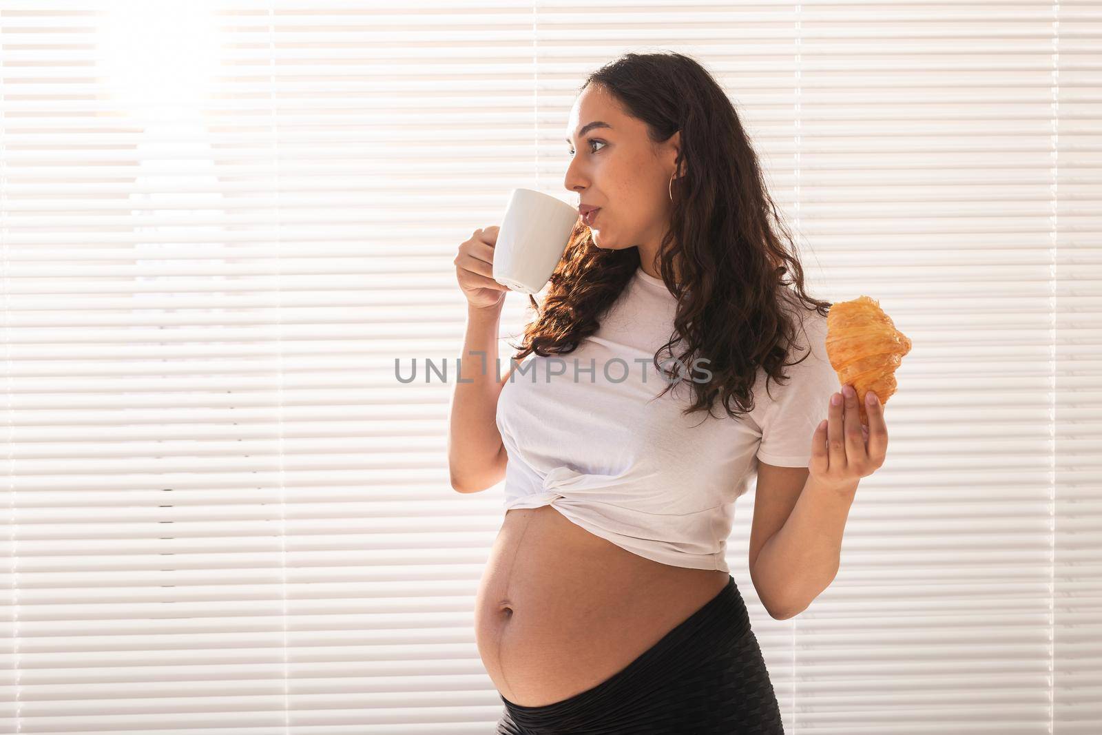 Pregnant woman eating breakfast. Pregnancy and maternity leave.