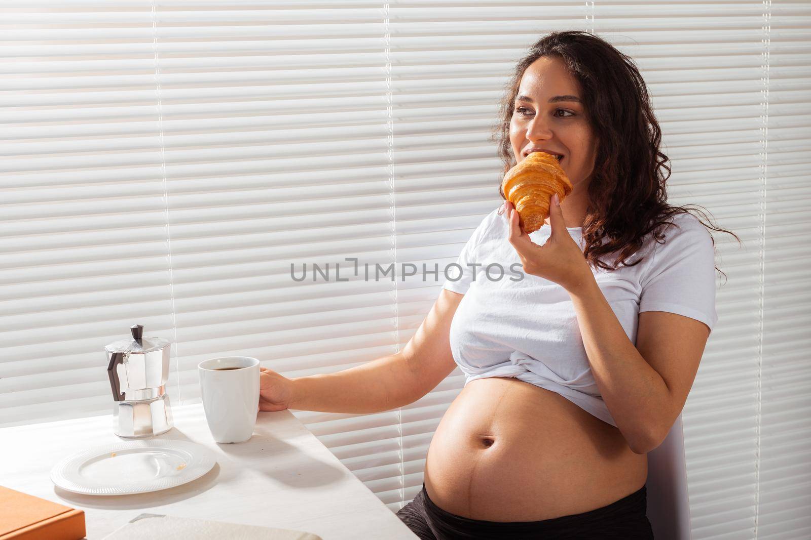 Pregnant woman eating breakfast. Pregnancy and maternity leave.