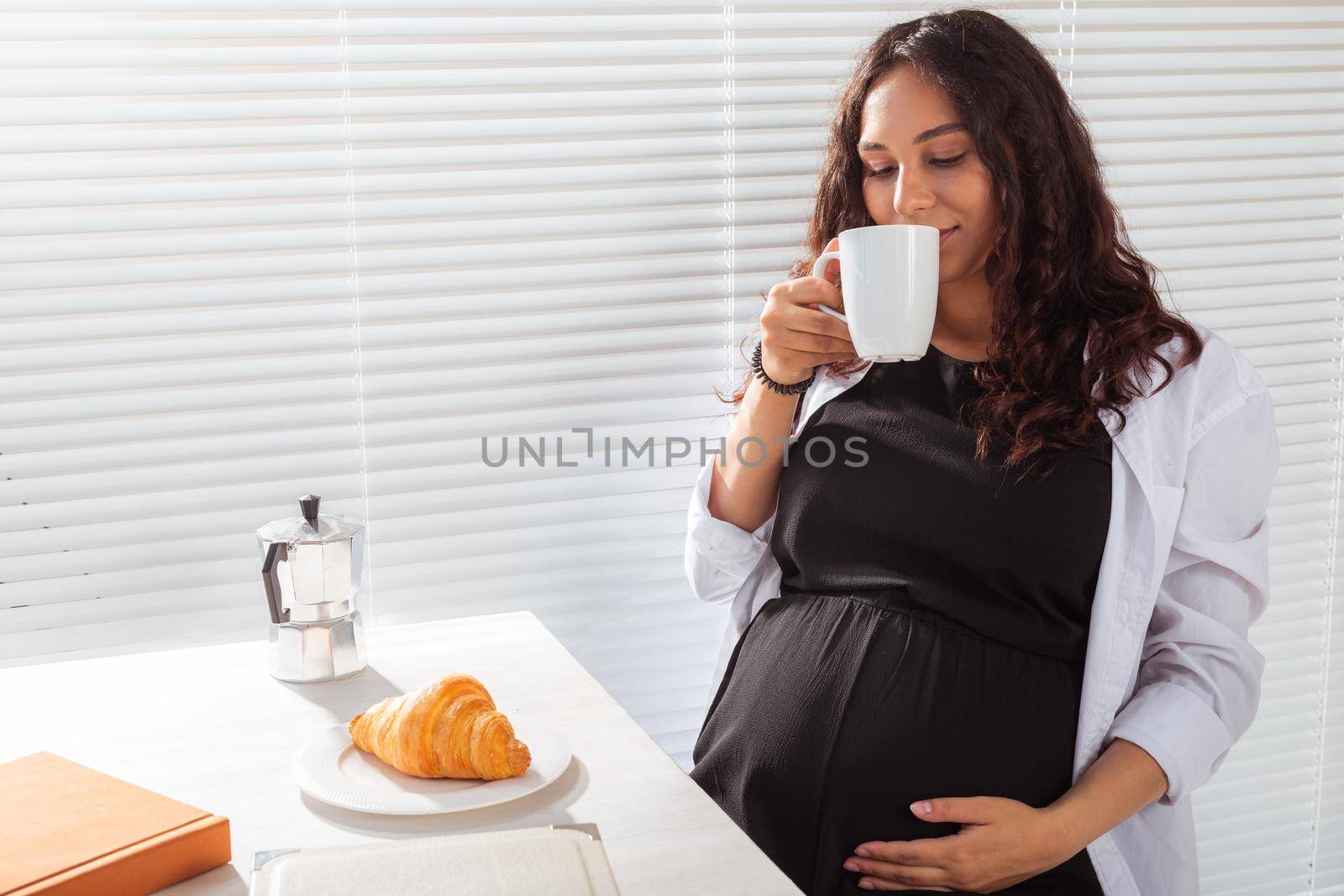Pregnant woman eating breakfast. Pregnancy and maternity leave.