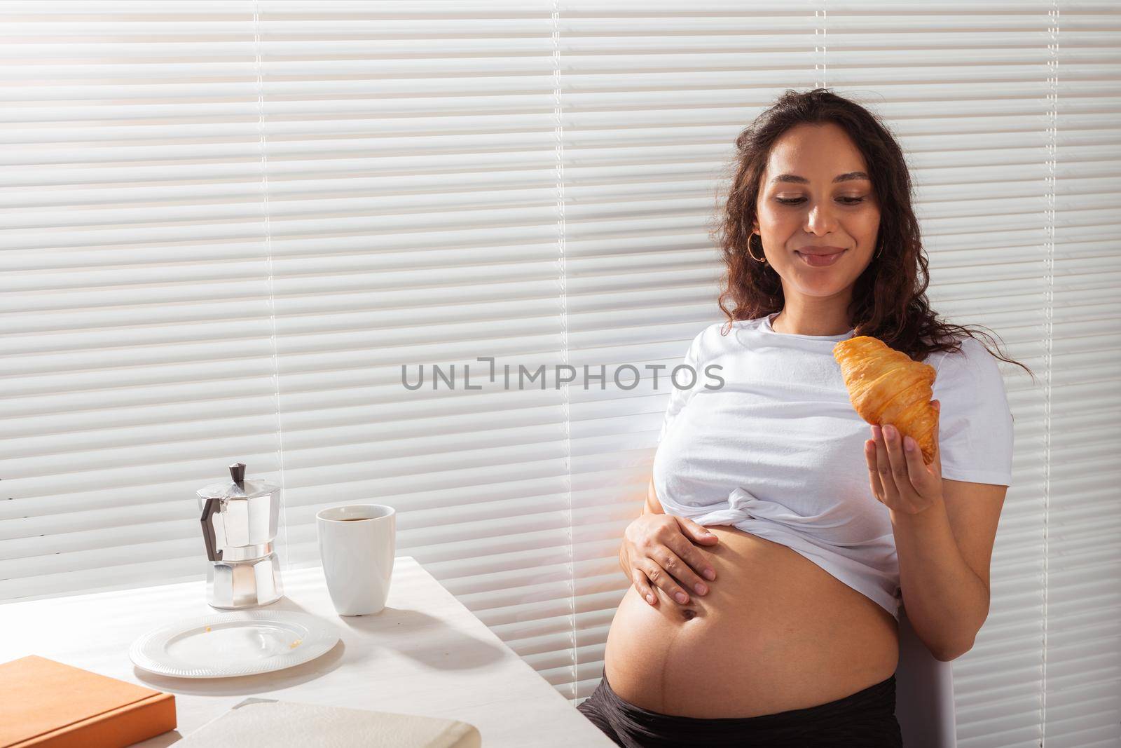 Pregnant woman eating breakfast. Pregnancy and maternity leave.