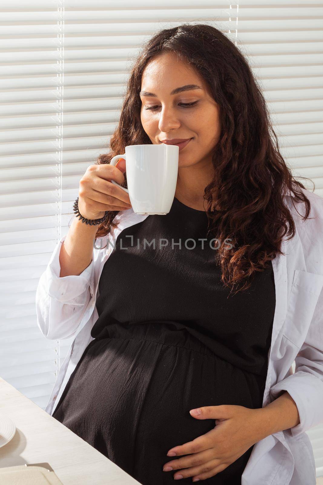 Pregnant woman eating breakfast. Pregnancy and maternity leave.