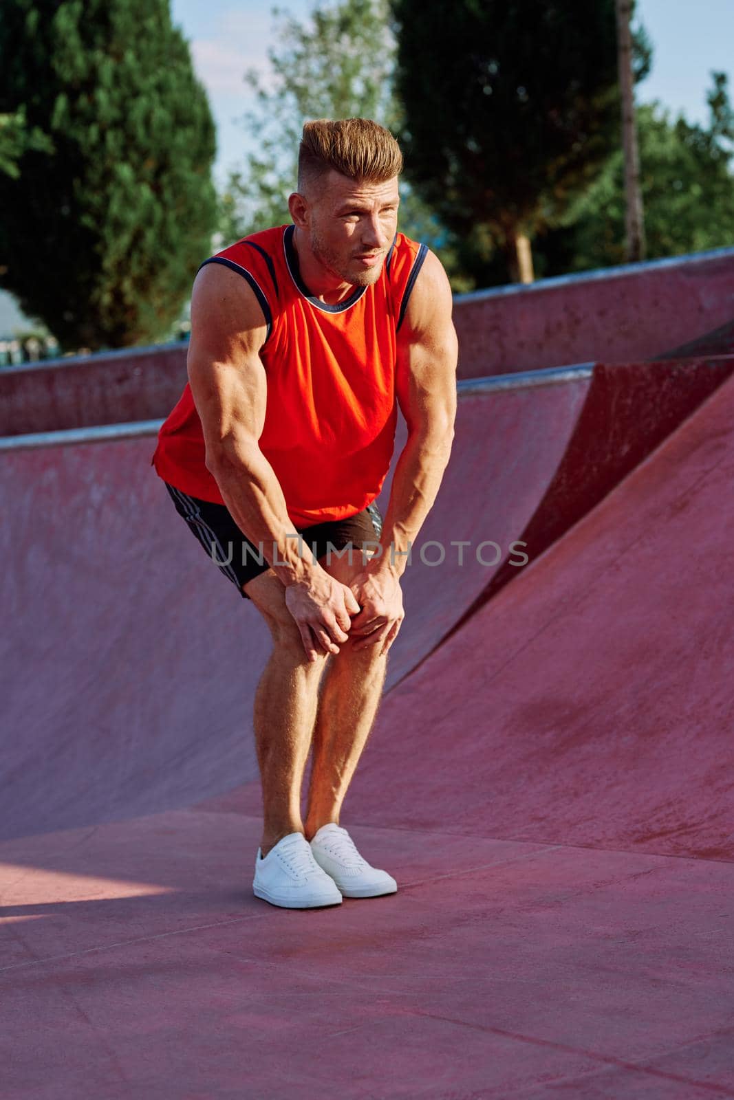 sports man on the playground in the park workout. High quality photo