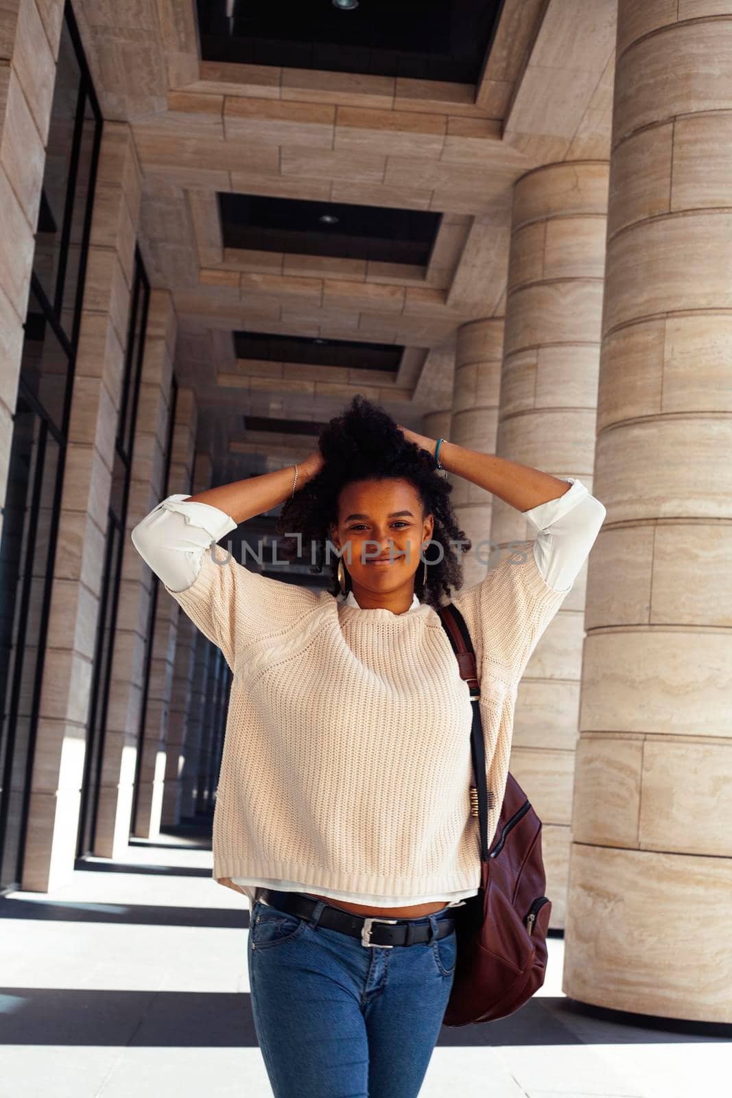 young pretty african girl posing cheerful on city background, lifestyle outdoor people concept close up