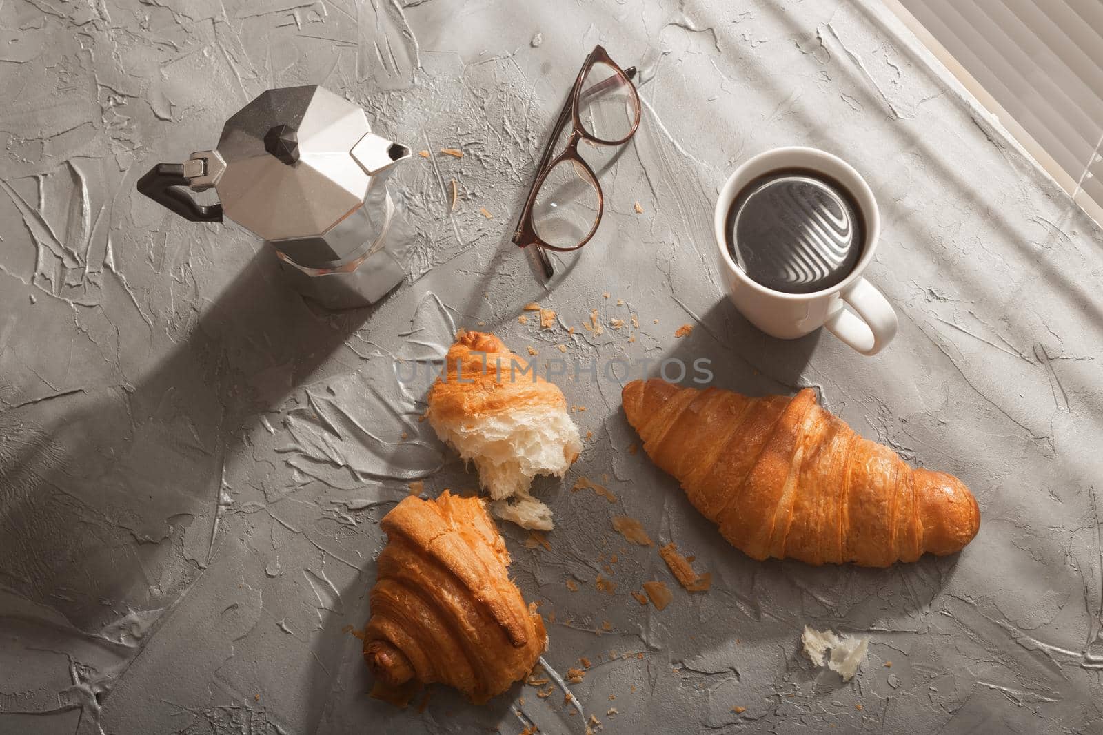 Breakfast with croissant on cutting board and black coffee. Morning meal and breakfast concept. Top view. by Satura86