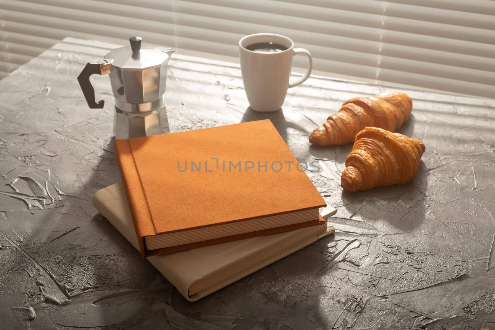 Still life for pleasant morning coffee turk cup and croissants with two books on the table. Lunch break or start the morning