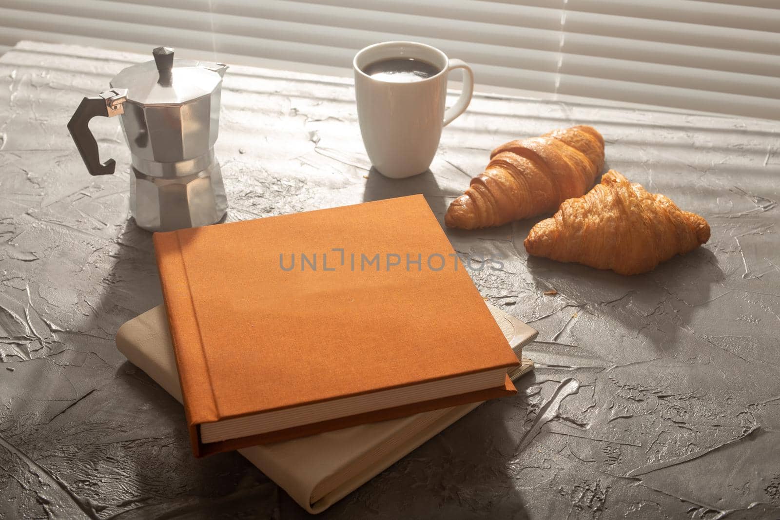 Still life for pleasant morning coffee turk cup and croissants with two books on the table. Lunch break concept or start the morning by Satura86