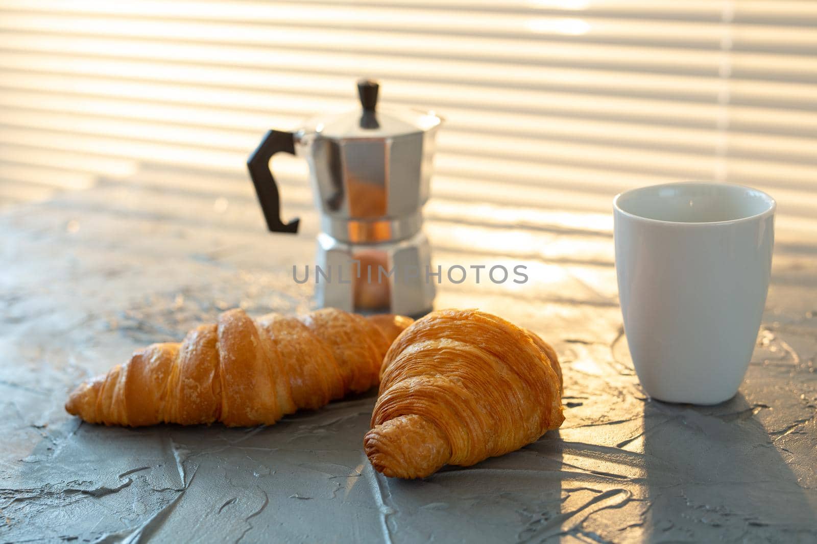 Breakfast with croissant on cutting board and black coffee. Morning meal and breakfast concept. by Satura86