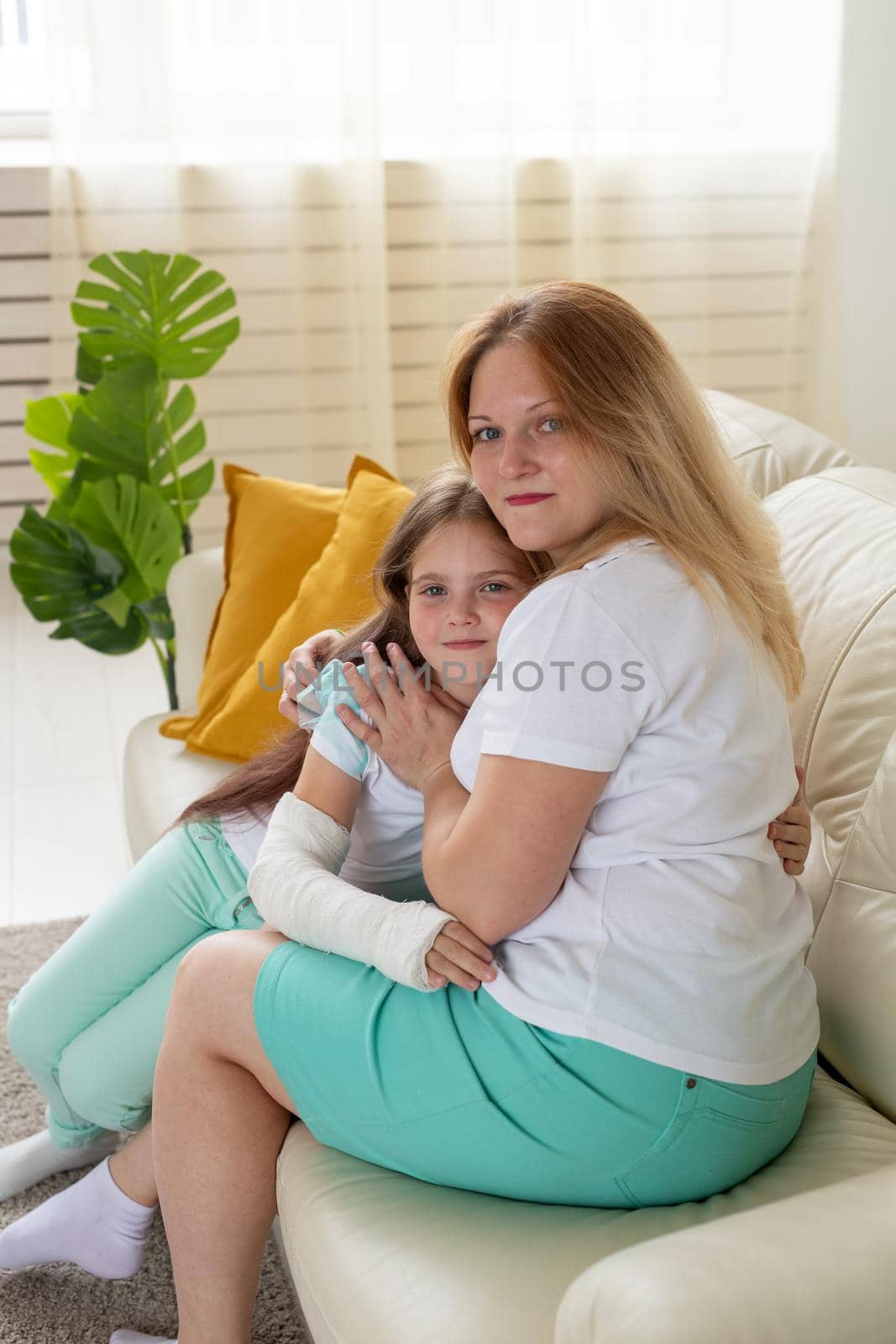 Child with broken arm and gypsum spend time at home with mother. Childhood illnesses, a positive outlook and recovery. by Satura86