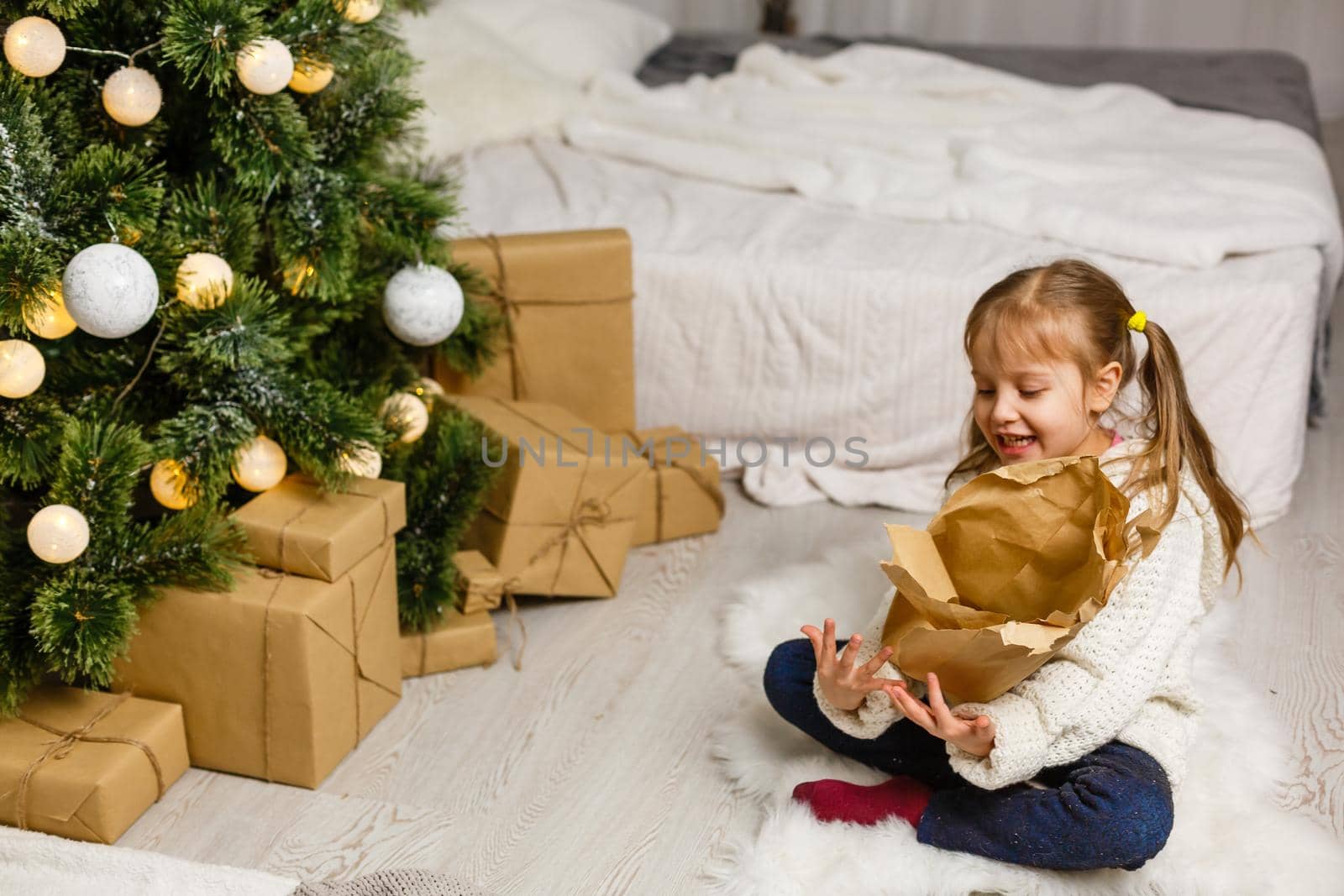 Happy little smiling girl with christmas gift box. by Andelov13