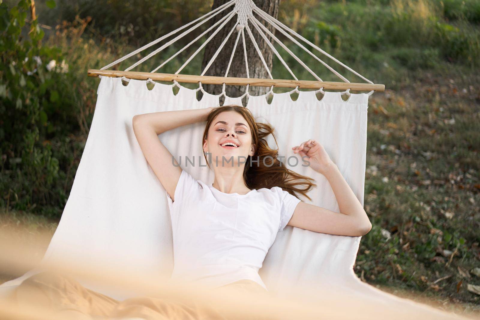 woman relaxing in nature in a hammock garden fresh air by Vichizh