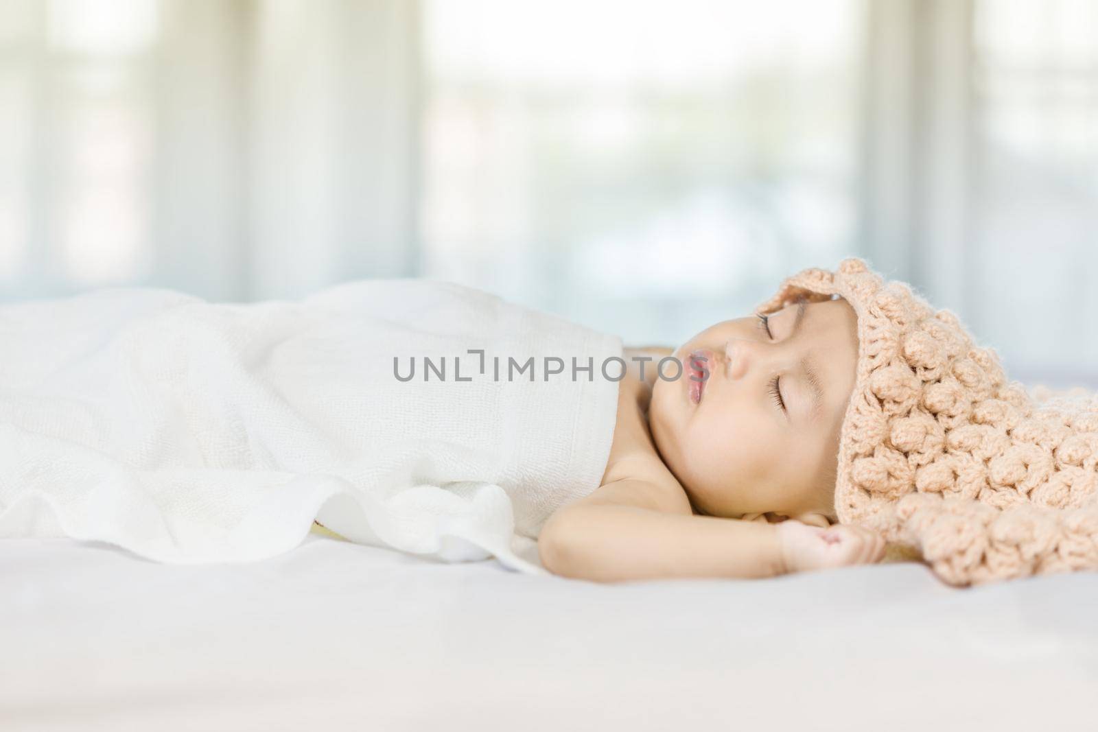 Baby sleeping on bed in the bedroom at home