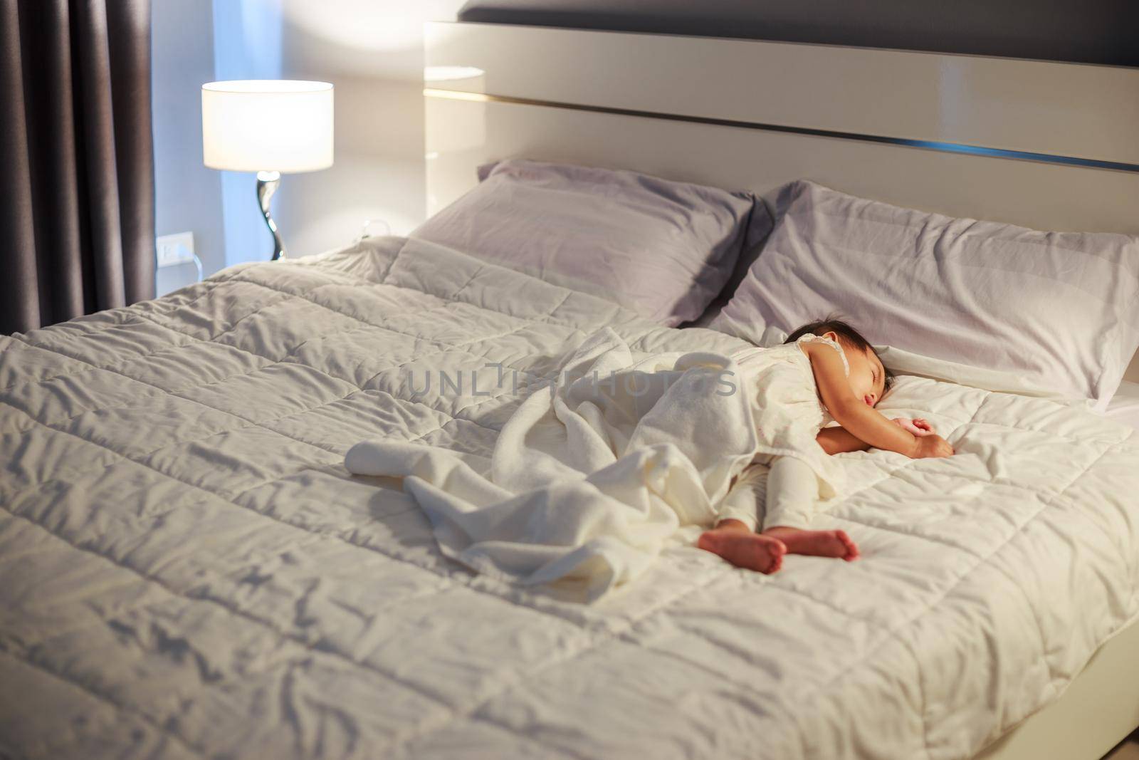 baby sleeping on bed in bedroom at home