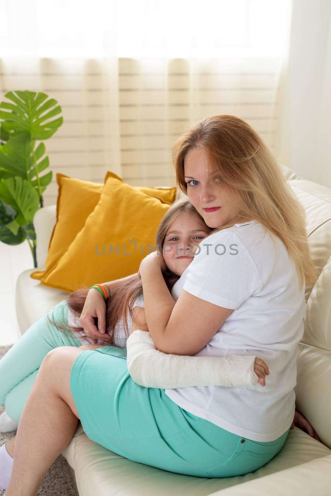 Child with broken arm and gypsum spend time at home with mother. Childhood illnesses, a positive outlook and recovery. by Satura86