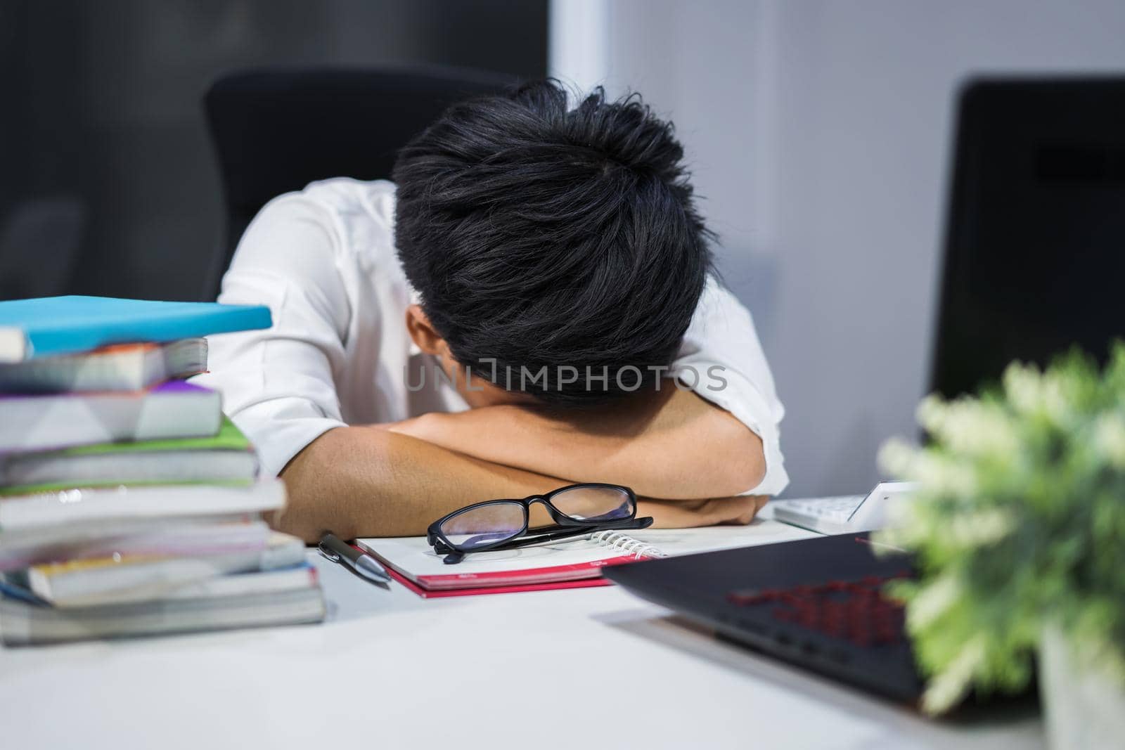 young student sitting and sleeping at desk with book and laptop  by geargodz