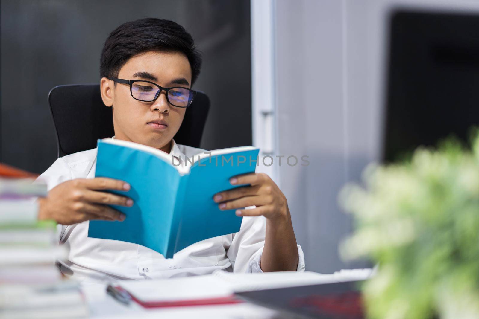 young student reading book by geargodz