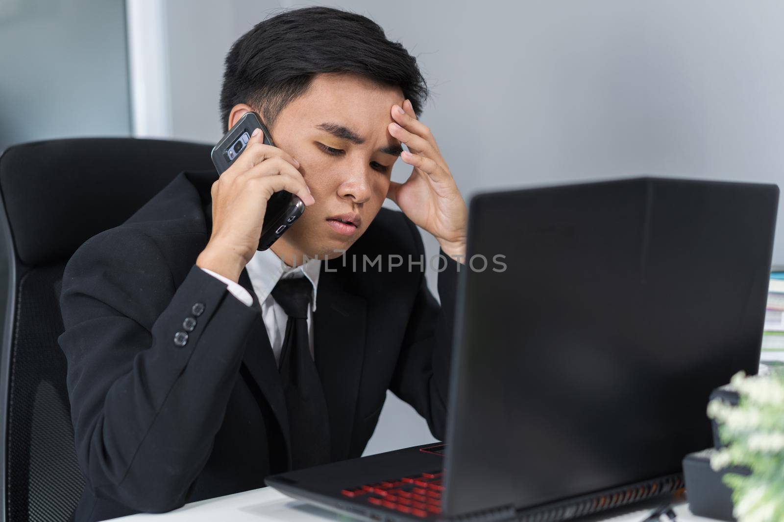 depressed man in suit talking on smartphone by geargodz