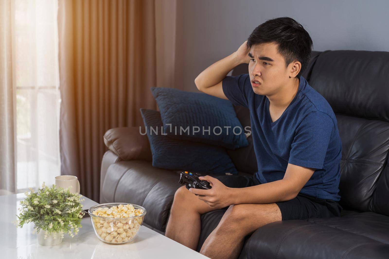 sad young man playing video games and loses