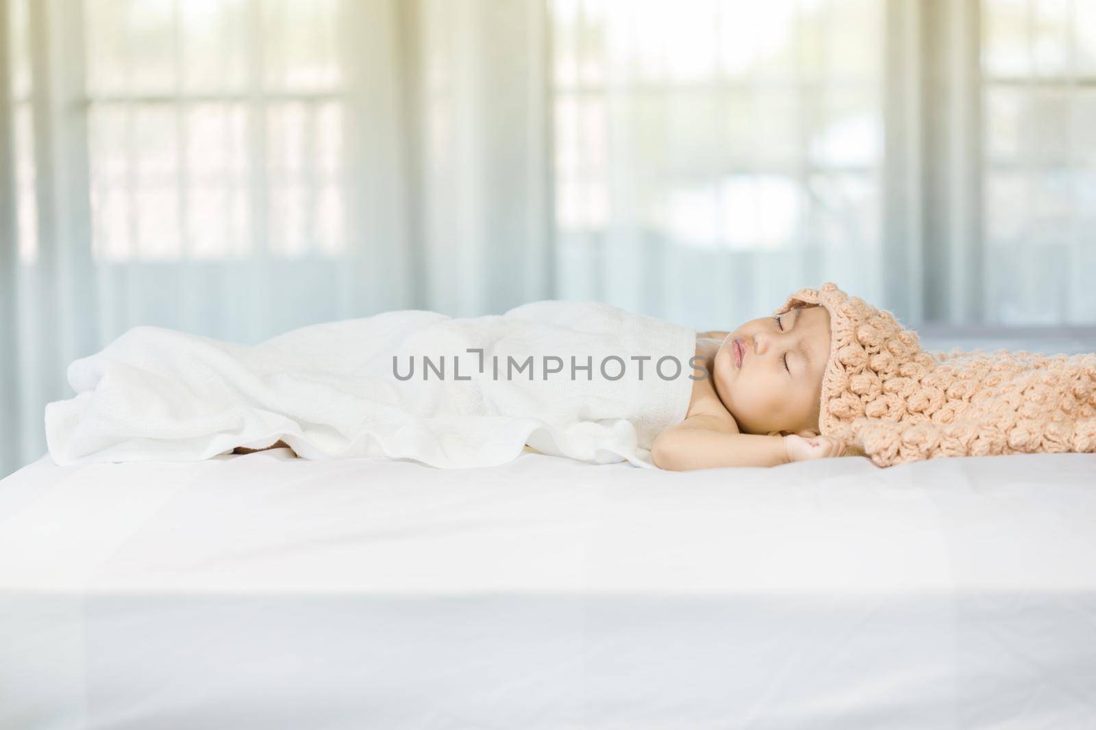 Baby sleeping on bed in the bedroom at home