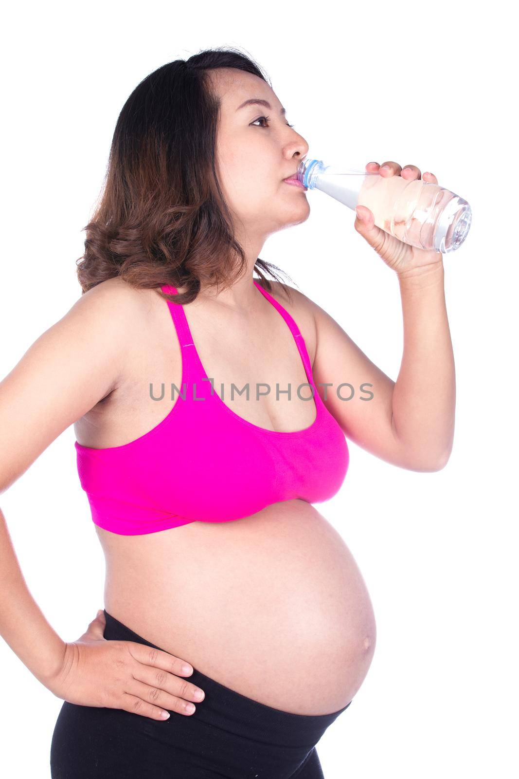 pregnant woman drink water from a bottle isolated on white  by geargodz