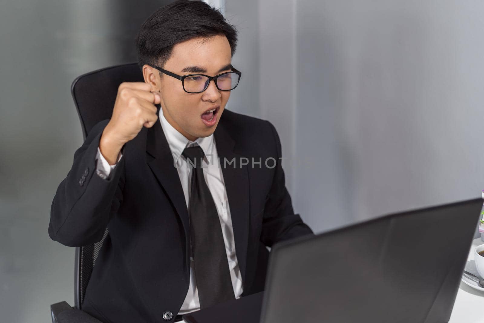 happy successful young business man using laptop computer