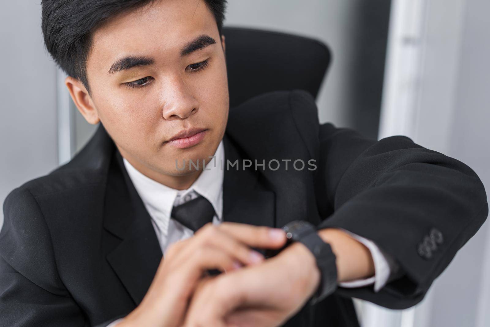 young business man checking time on smart watch 