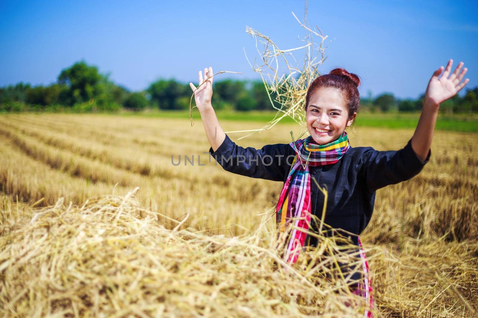 farmer woman relaxing with the straw in field, Thailand