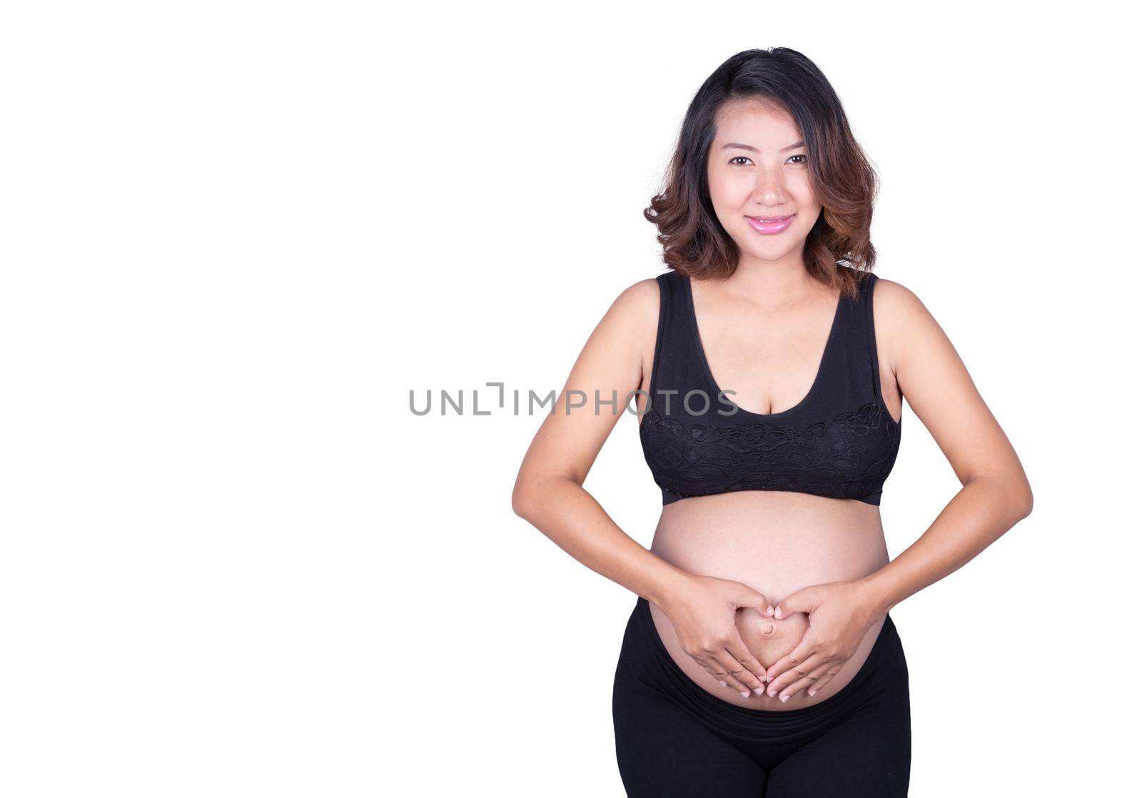 Pregnant Woman holding her hands in a heart shape on her belly isolated on white background