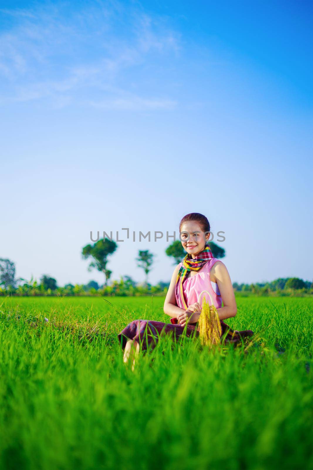 beautiful farmer woman sitting in rice filed, Thailand by geargodz