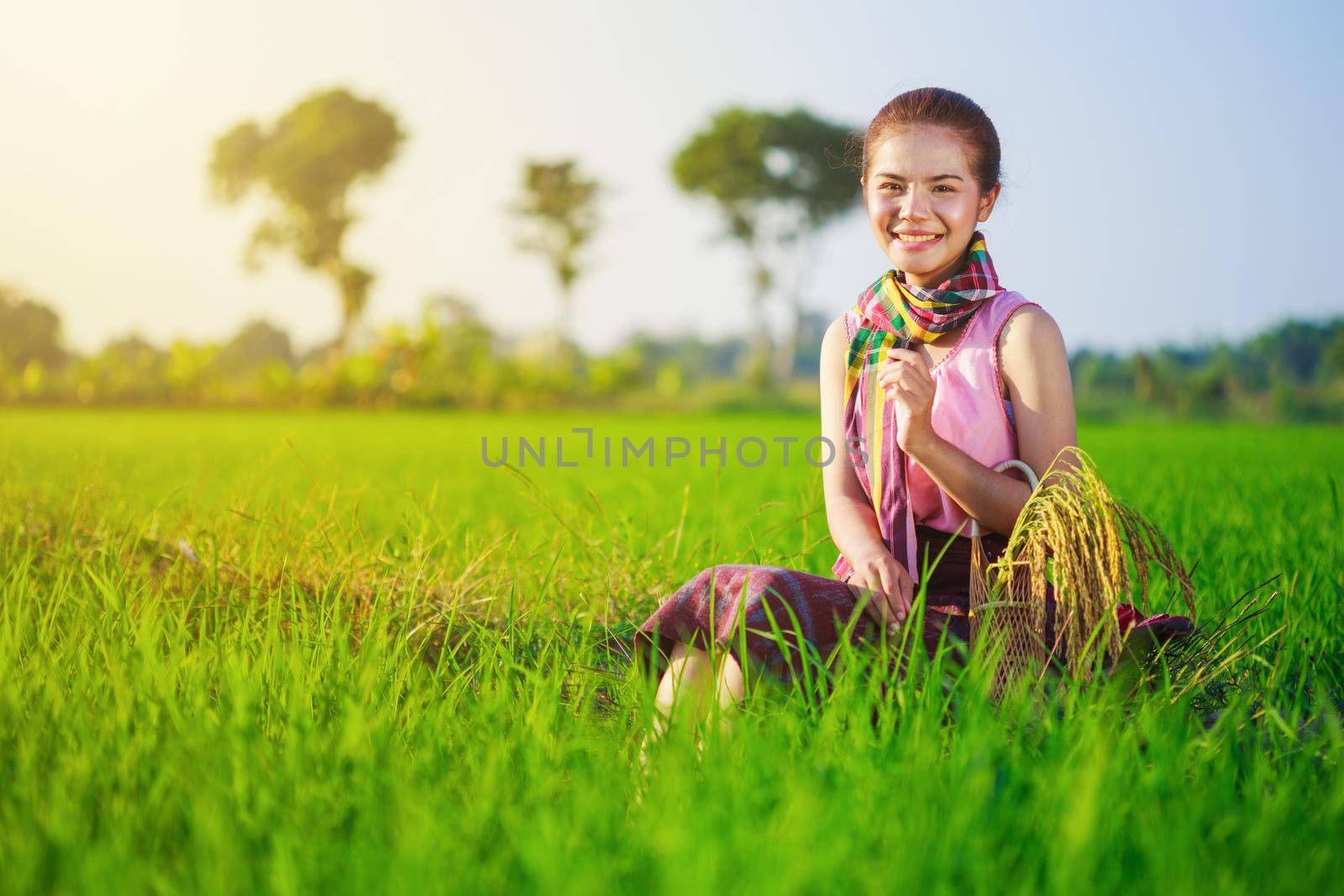 beautiful farmer woman sitting in rice filed, Thailand by geargodz