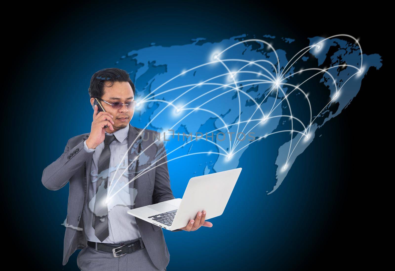 business man talking on mobile phone and using laptop with world map for internet connectivity concept by geargodz