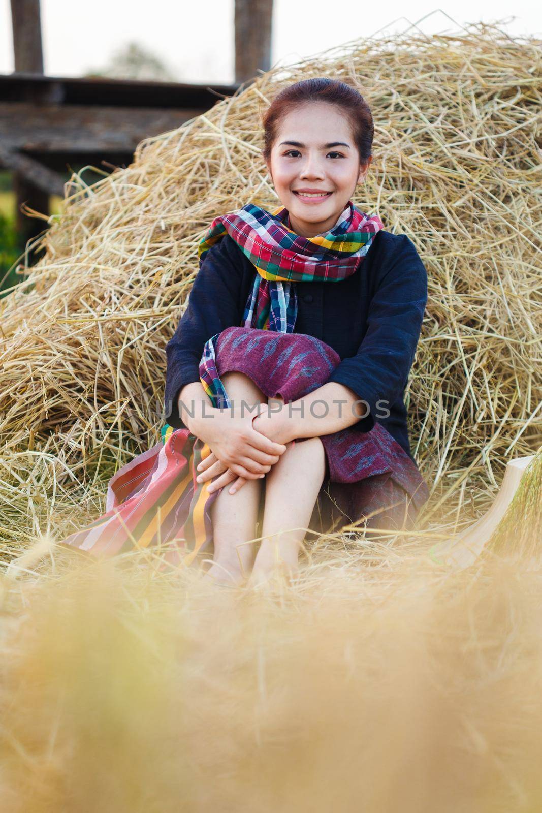 farmer woman resting with the straw in field, Thailand