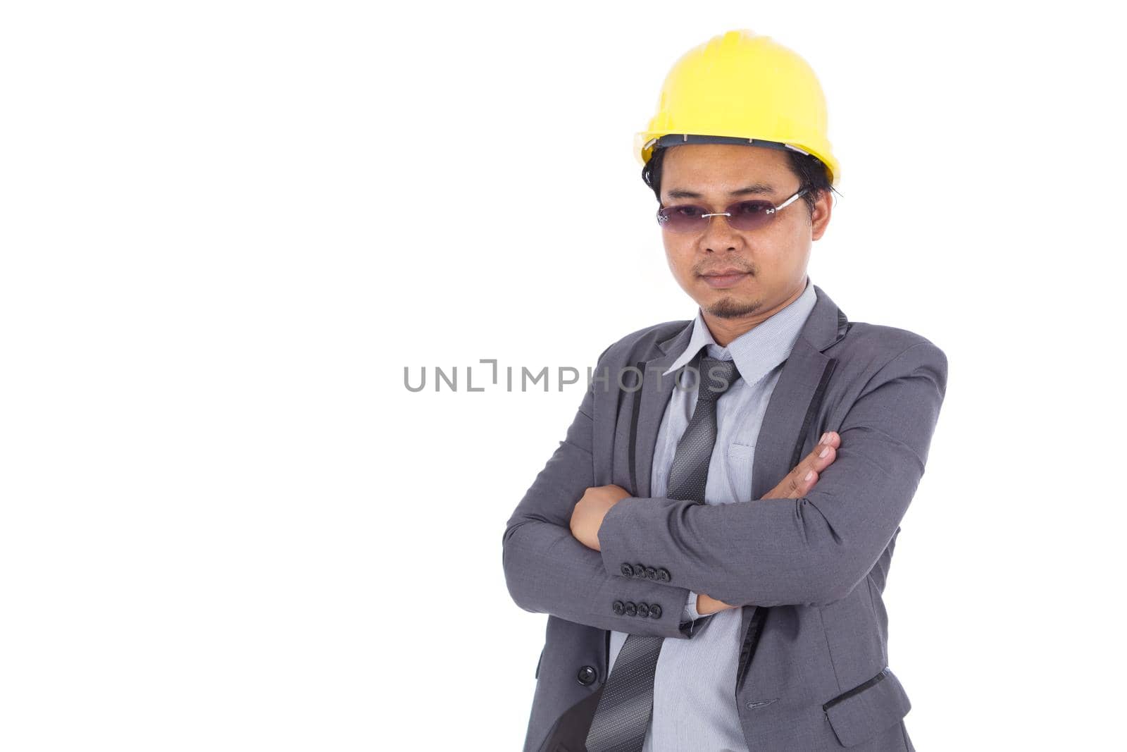 engineer in yellow helmet with arms crossed, isolated on white