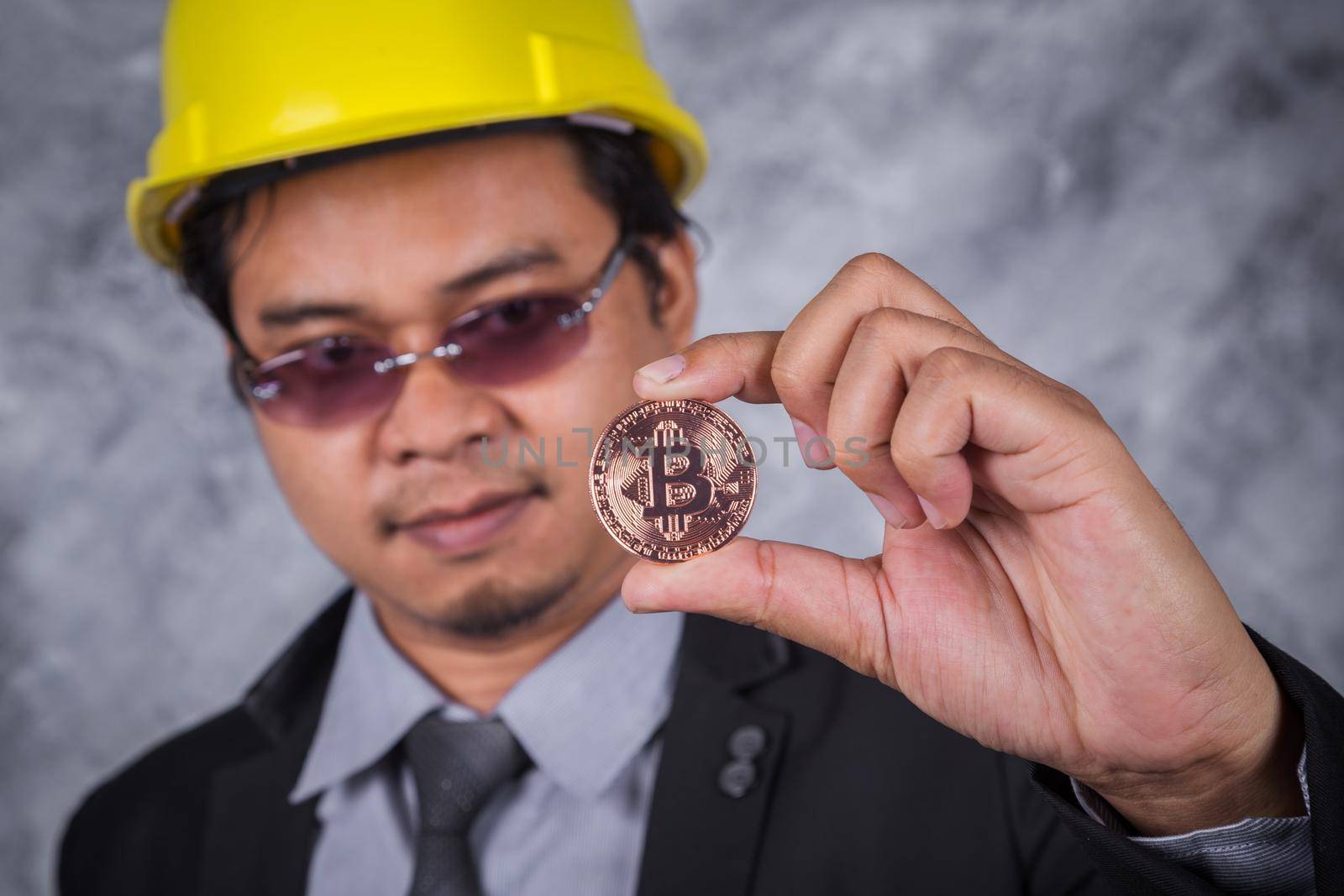 bitcoin in hand of engineer with suit