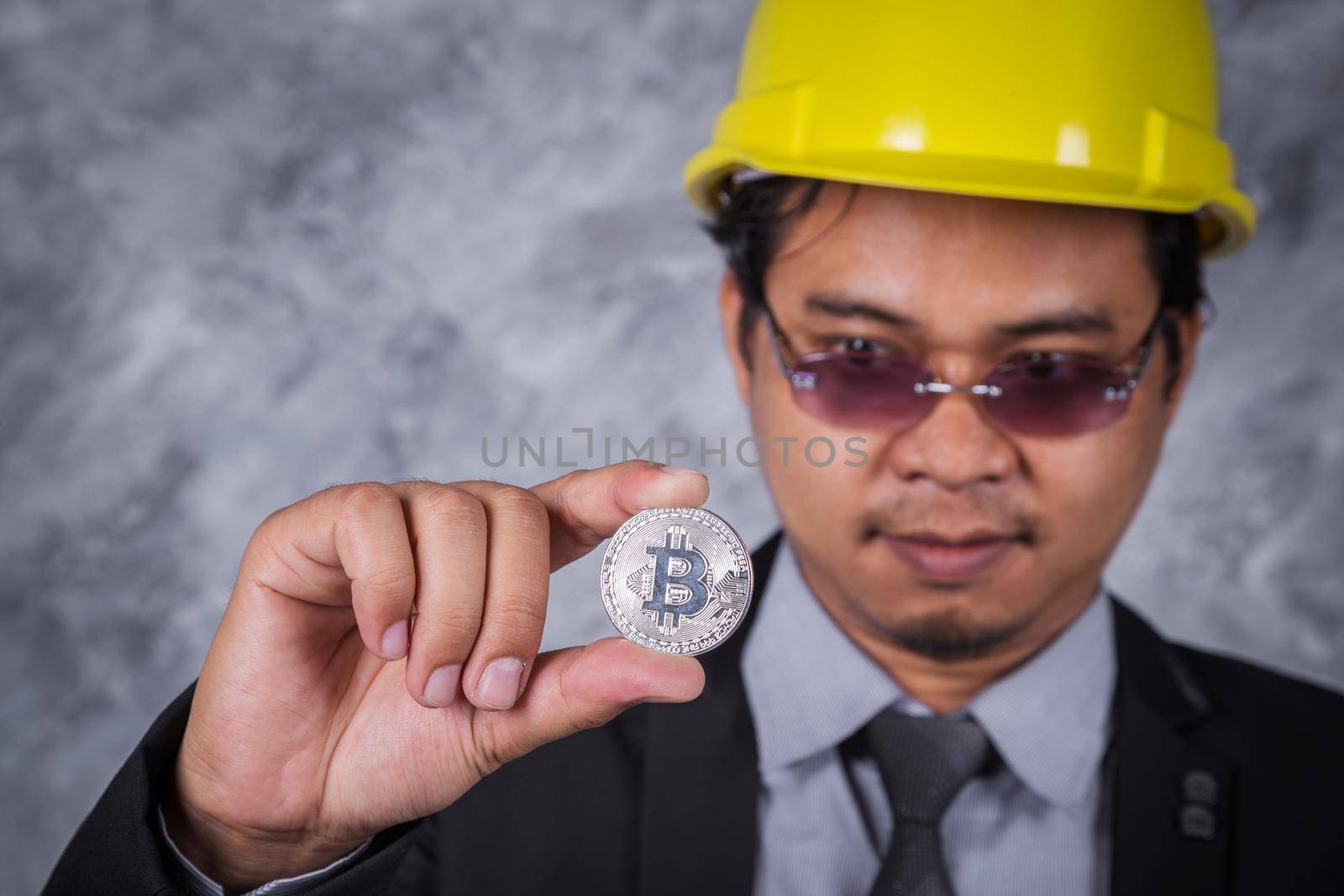 bitcoin in hand of engineer with suit