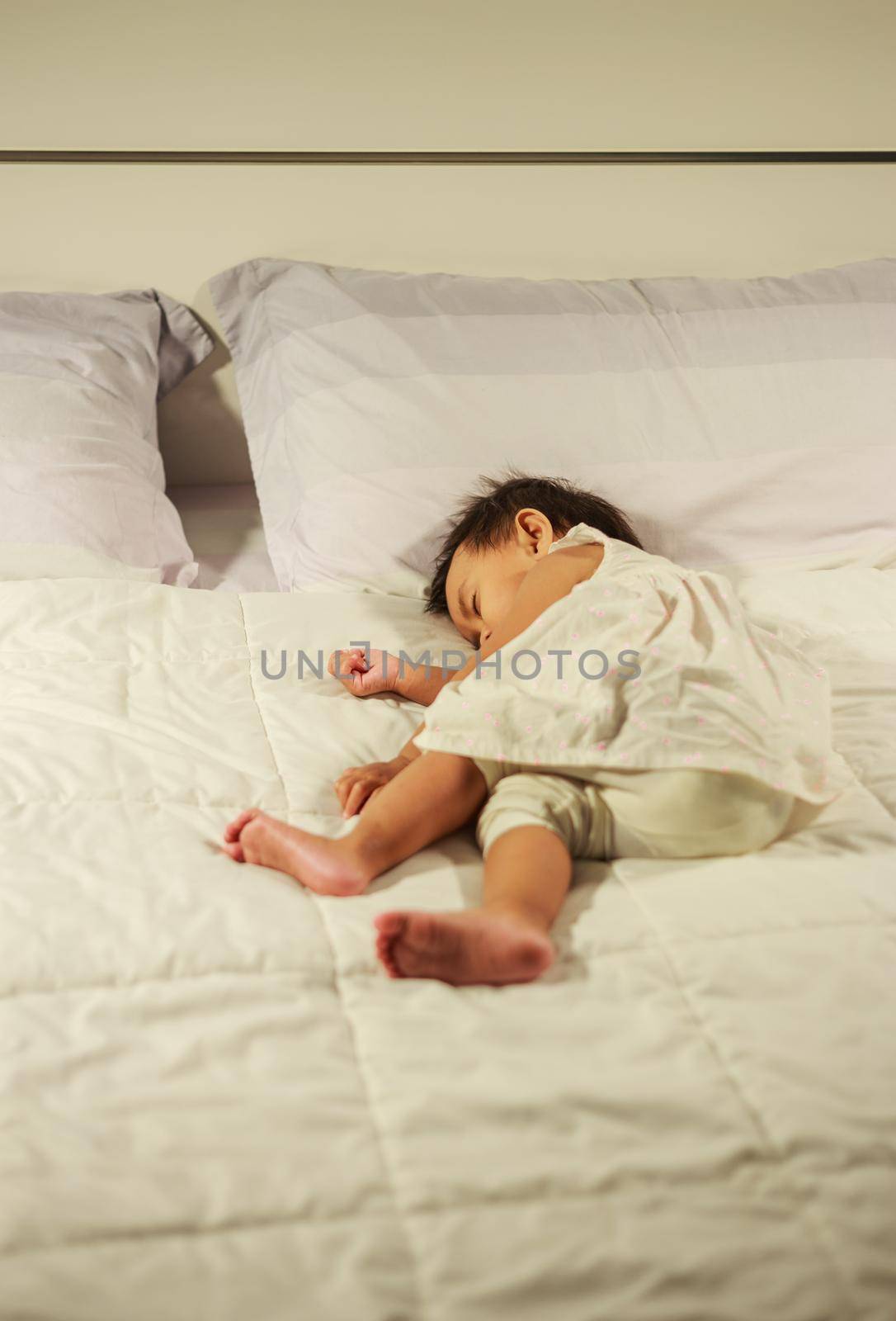 baby sleeping on bed in bedroom at home