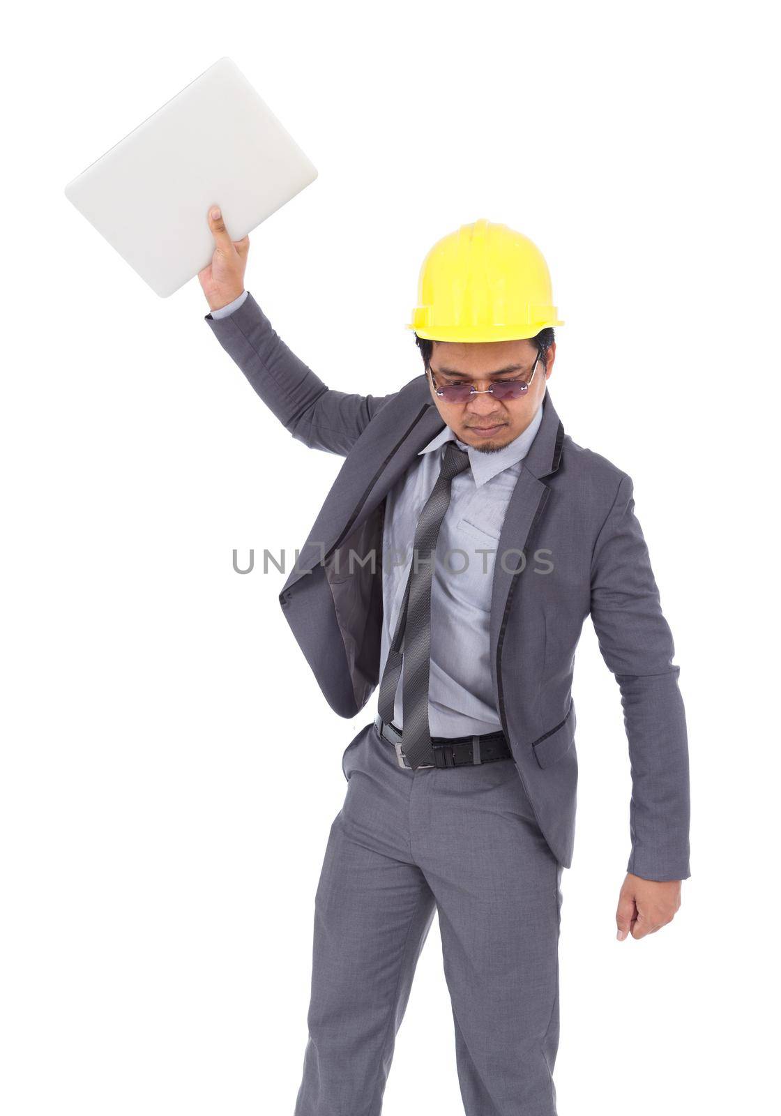 very angry engineer is throwing away his laptop isolated on a white background