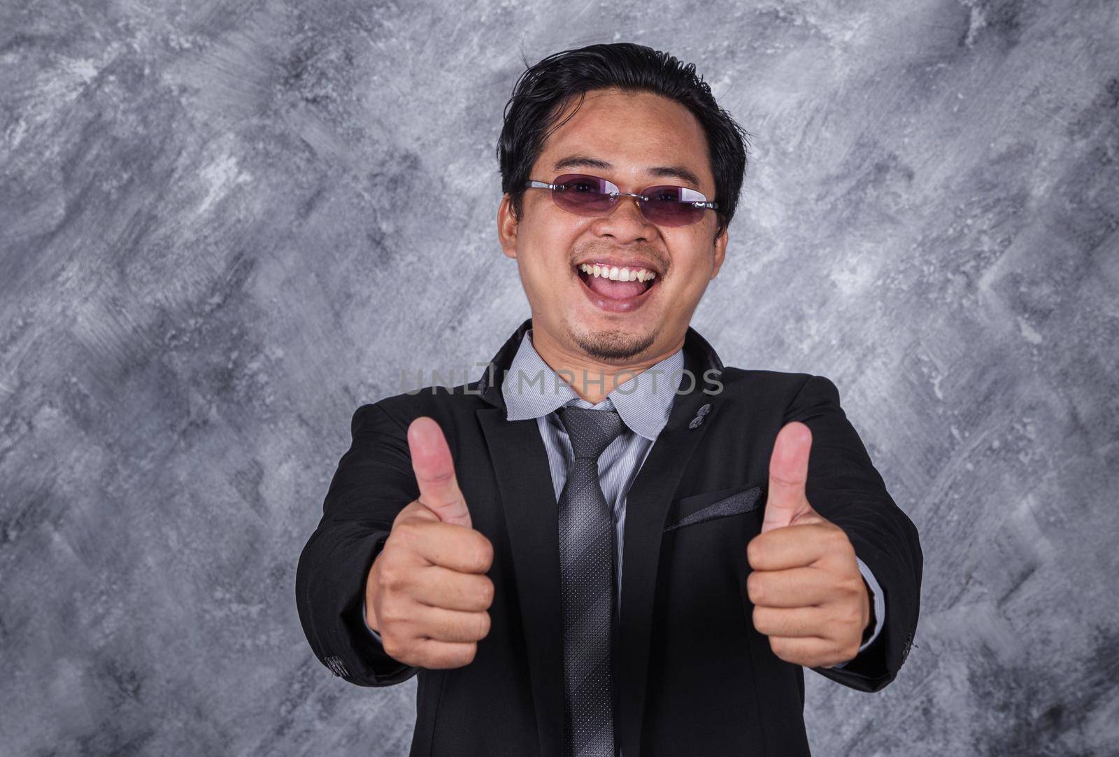 young business man in suit with thumb up 