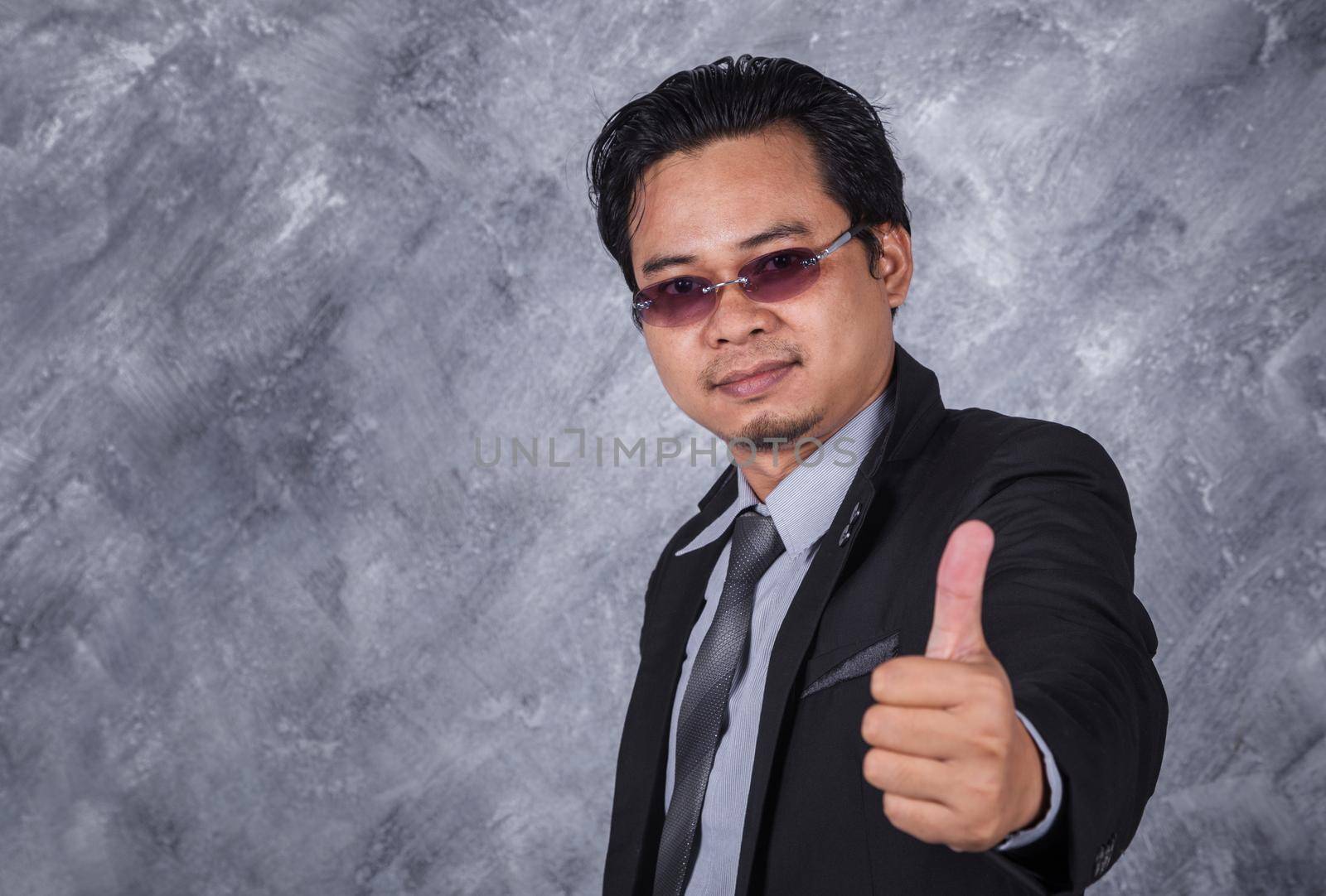 young business man in suit with thumb up 