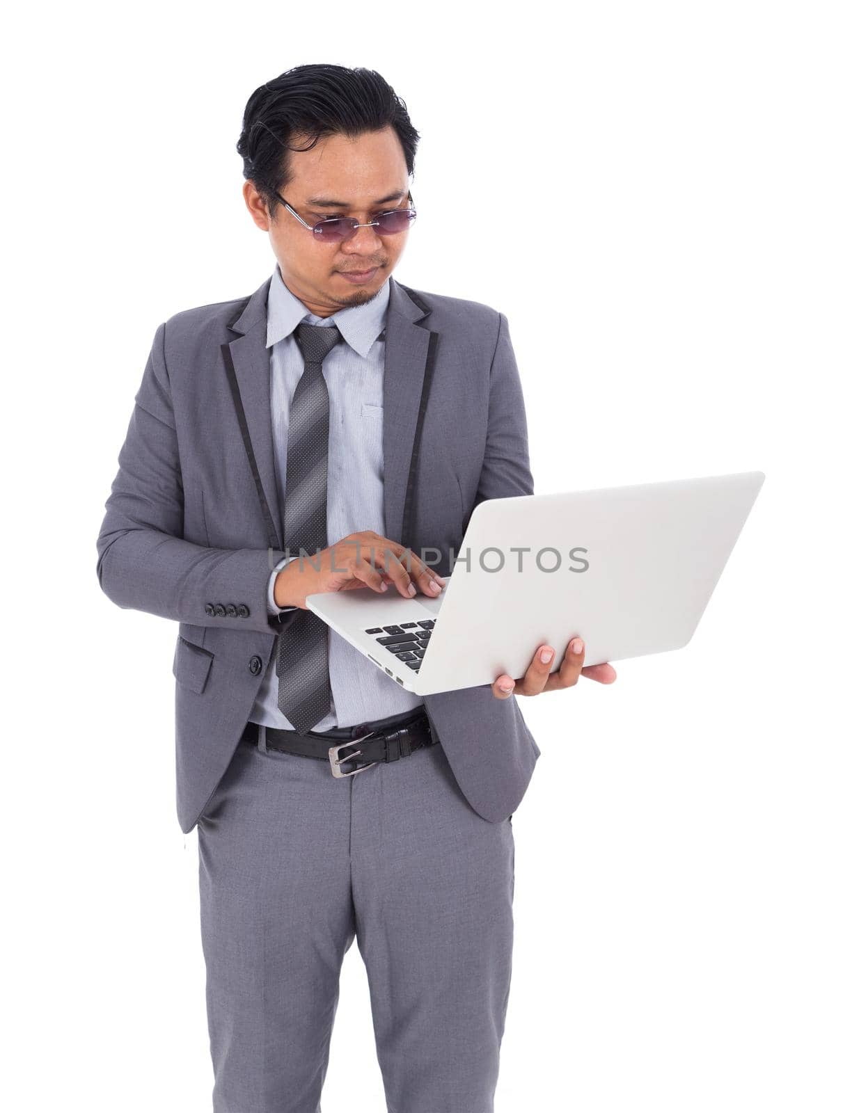 business man holding laptop isolated on white background by geargodz