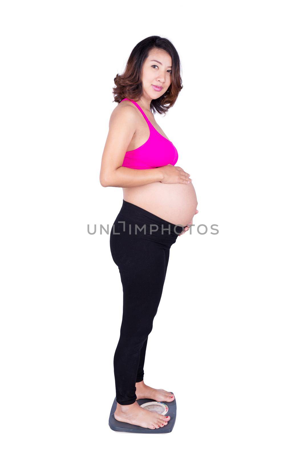 Worried pregnant woman standing on scale isolated on white by geargodz
