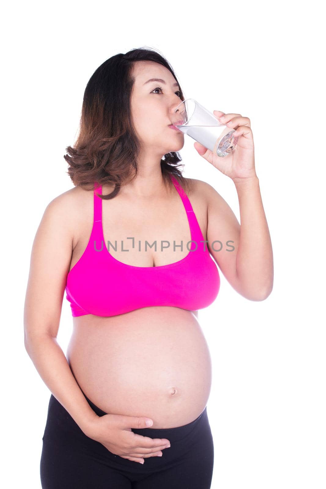 pregnant woman drink water from a glass isolated on white by geargodz