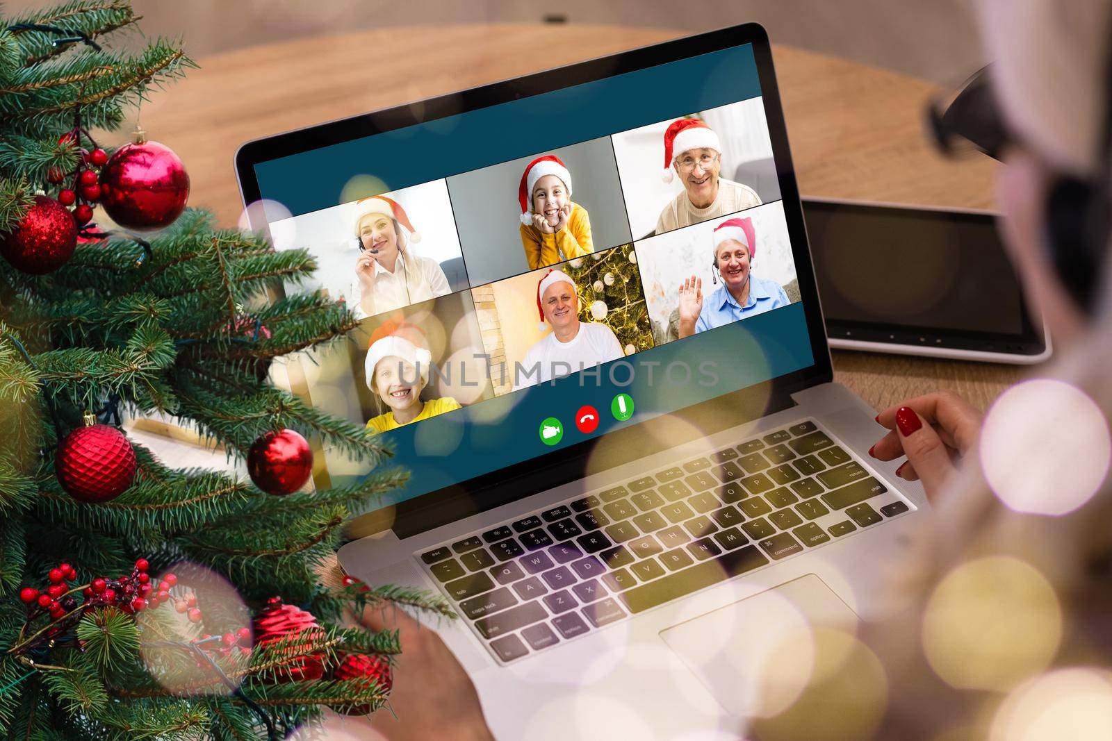 video call with happy diverse children on laptop computer in his workshop. Self-isolation and virtual online celebration at home concept. Christmas.