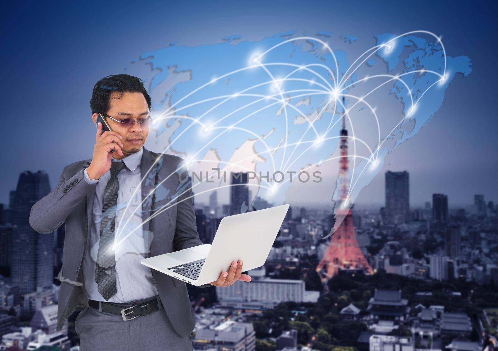 business man talking on mobile phone and using laptop with world map for social and internet connectivity concept
