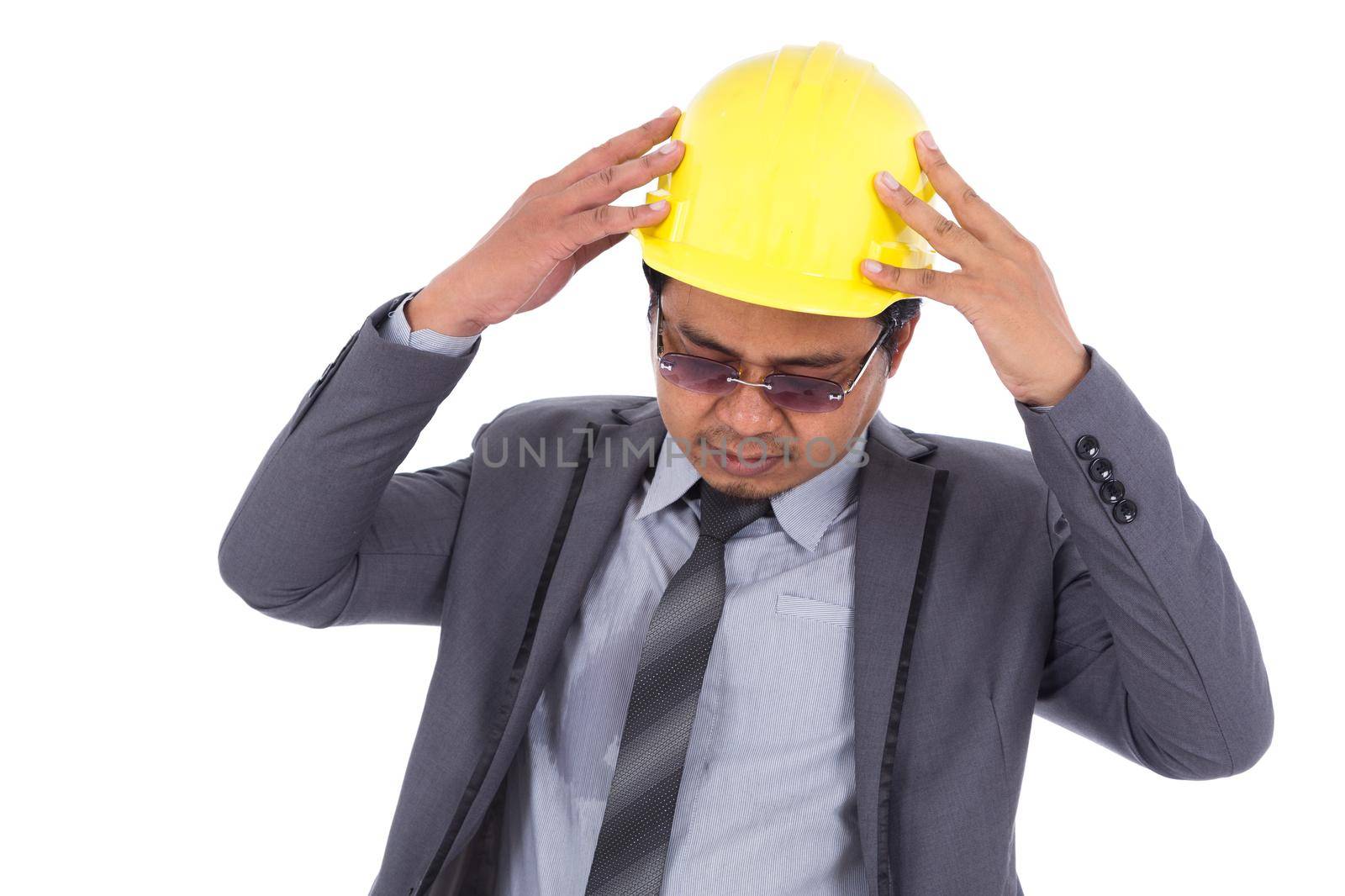 engineer in suit with headache and problems isolated on a white background