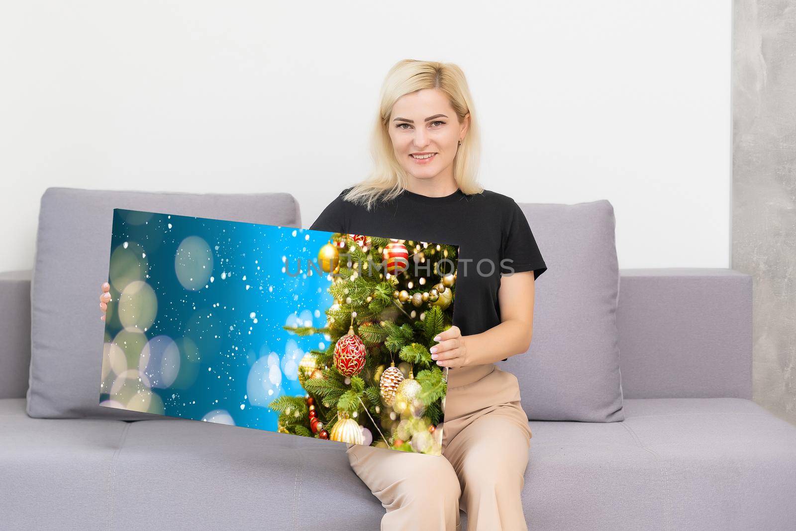 woman holding a photo canvas with a picture of christmas by Andelov13